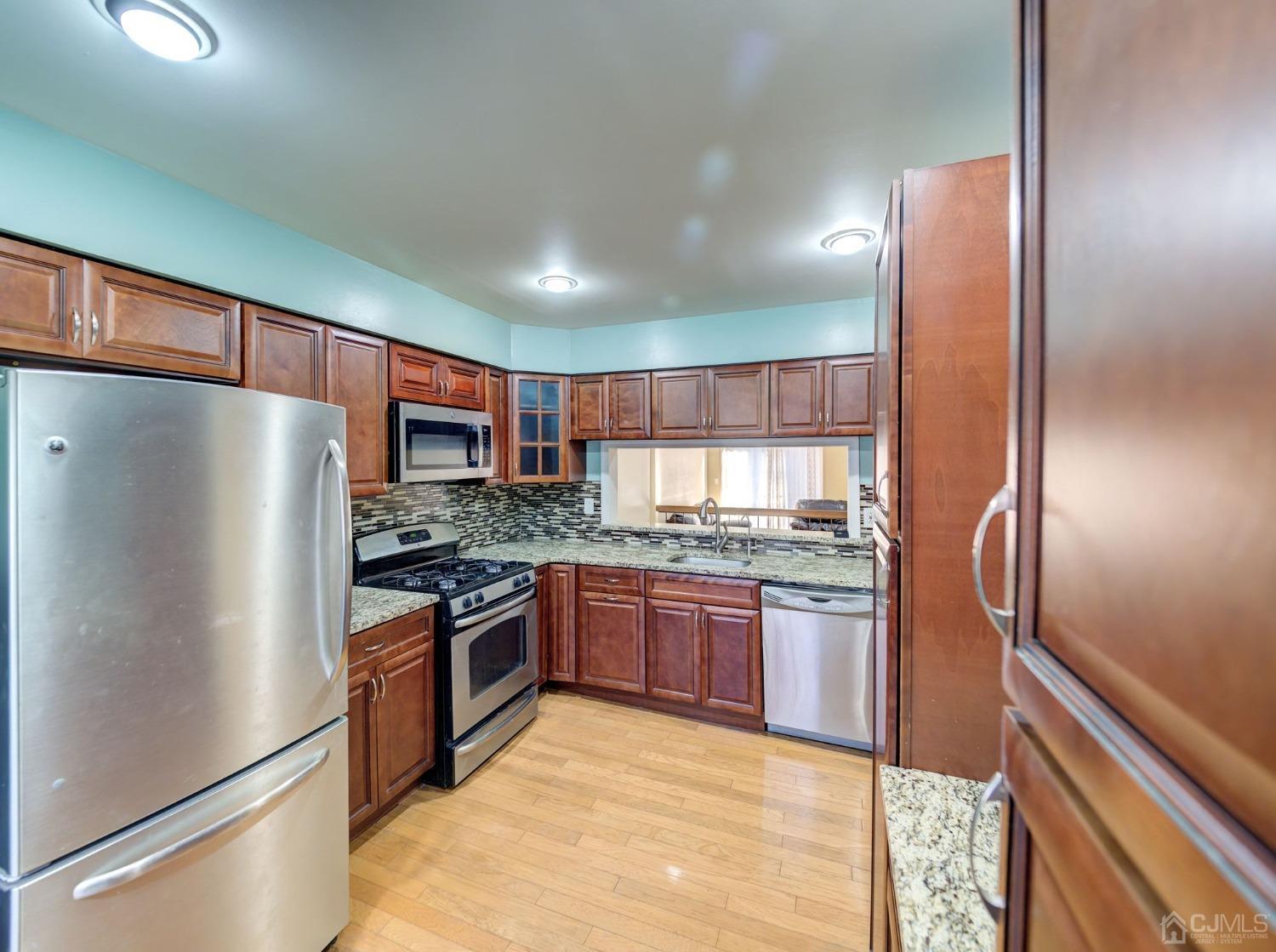 3802 Cricket Circle Edison, NJ 08820 - Photo 5 of 26 a kitchen with stainless steel appliances granite countertop a refrigerator a stove and a sink