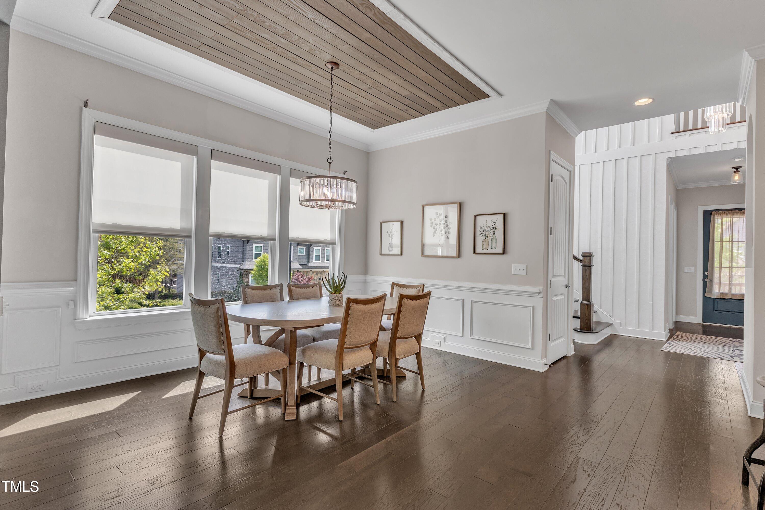 8121 Greys Landing Way Raleigh, NC 27615 - Photo 13 of 95 a view of a dining room with furniture window and wooden floor