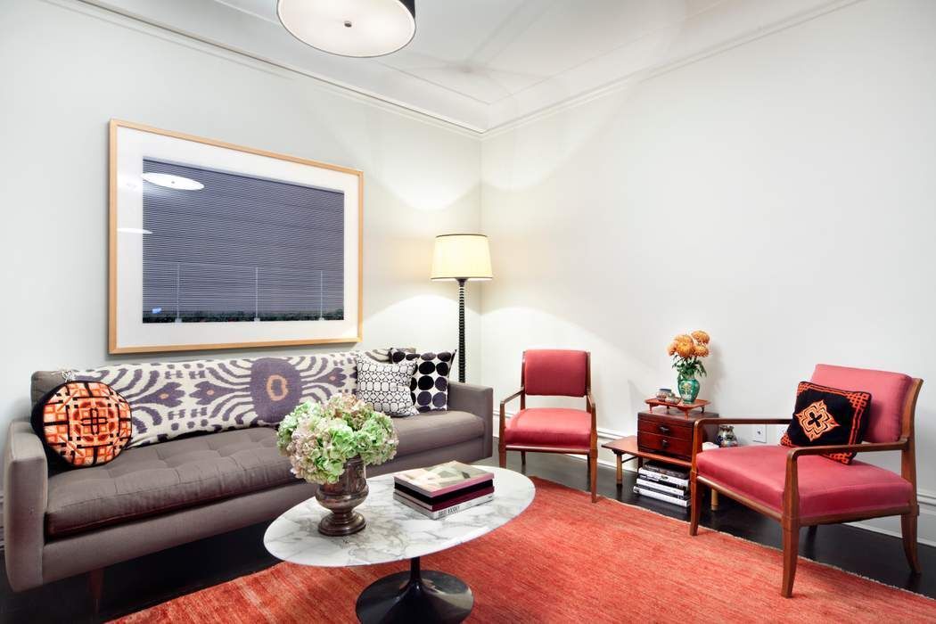 790 Riverside Drive, Unit 1J Manhattan, NY 10032 - Photo 5 of 22 a living room with furniture and a lamp