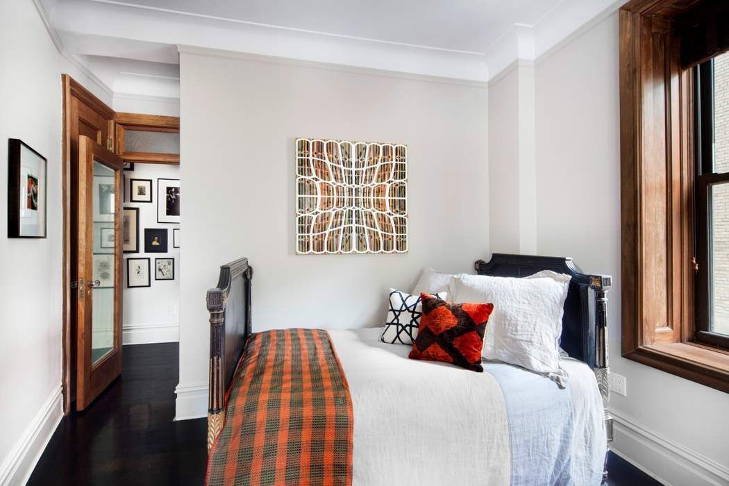 790 Riverside Drive, Unit 1J Manhattan, NY 10032 - Photo 9 of 22 a bedroom with a bed and wooden floor