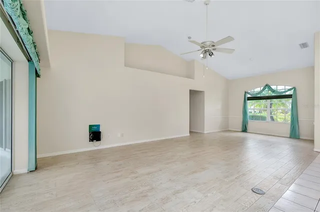 a kitchen with white cabinets and refrigerator