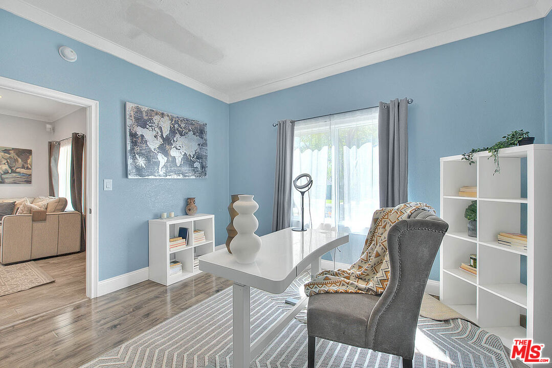 283 West Howard Street Pasadena, CA 91103 - Photo 12 of 21 a living room with furniture a refrigerator and a dining table with wooden floor