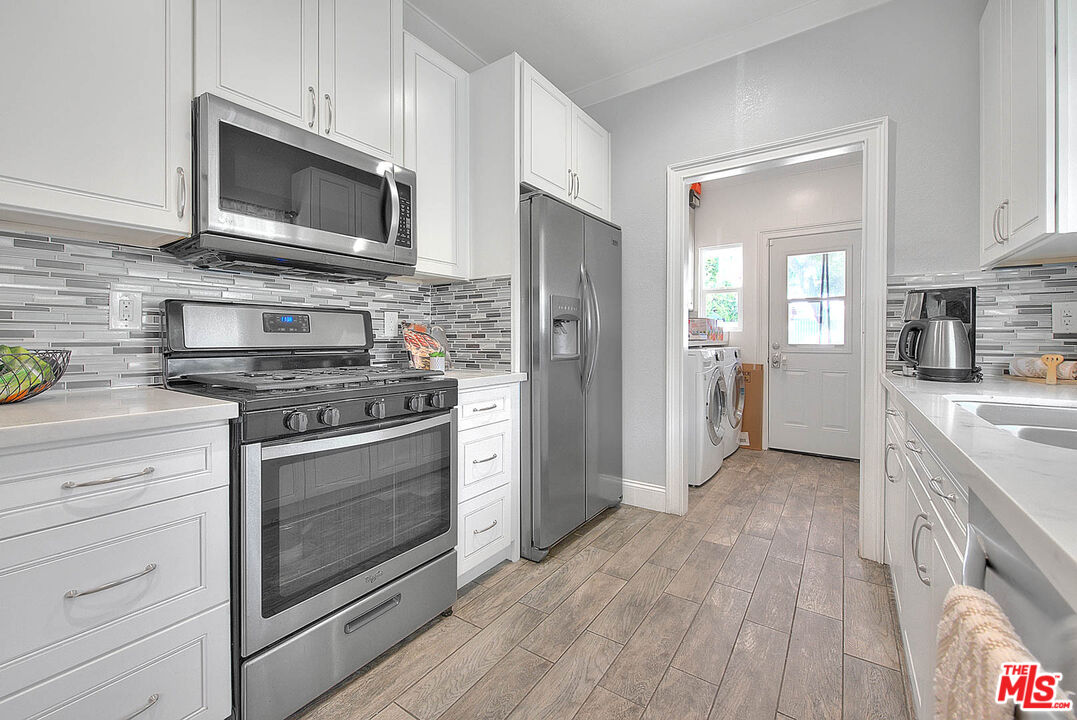 283 West Howard Street Pasadena, CA 91103 - Photo 7 of 21 a kitchen with stainless steel appliances a stove microwave and refrigerator