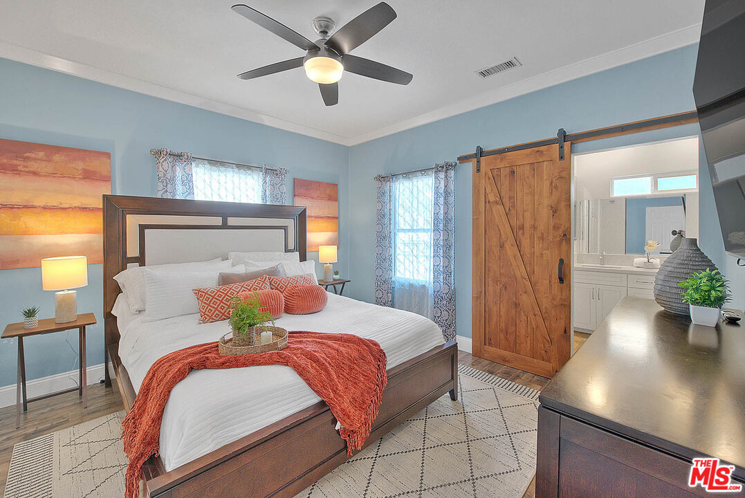 283 West Howard Street Pasadena, CA 91103 - Photo 8 of 21 a bedroom with a large bed and a chandelier