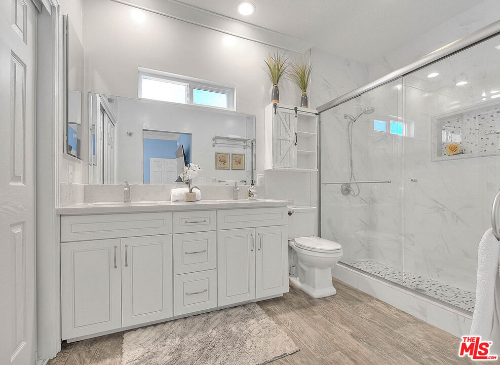 283 West Howard Street Pasadena, CA 91103 - Photo 10 of 21 a bathroom with a toilet sink and a mirror