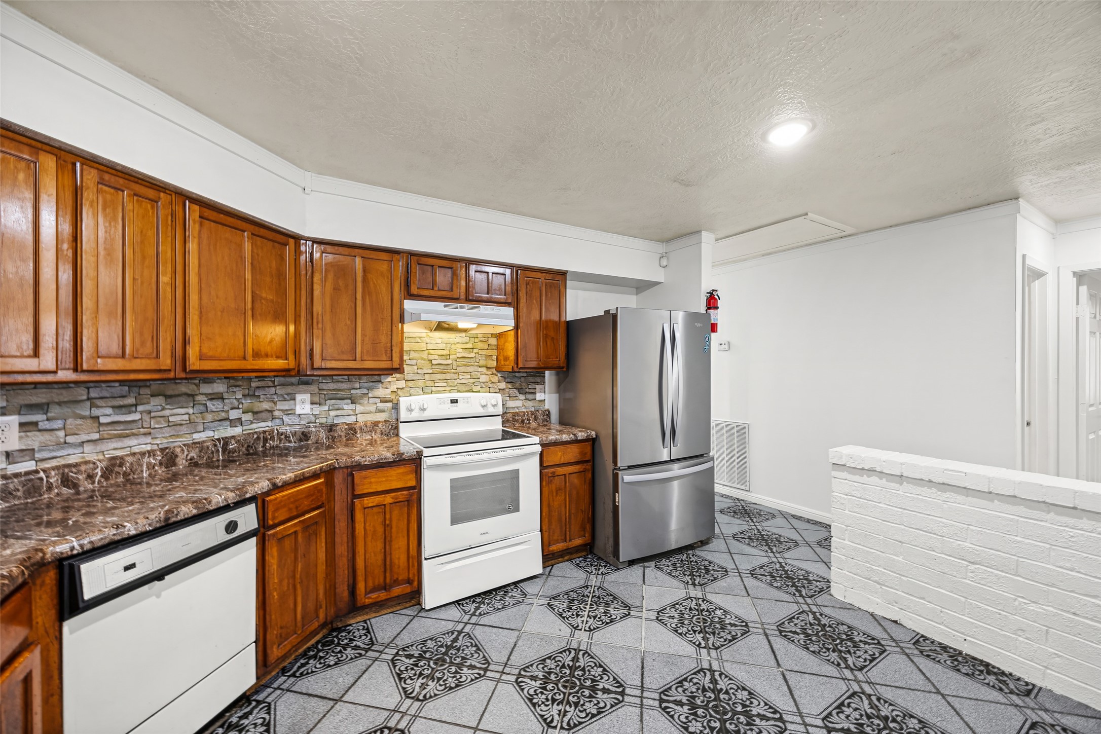 7226 Ridgeberry Drive Houston, TX 77095 - Photo 8 of 31 a kitchen with stainless steel appliances granite countertop a refrigerator sink and stove
