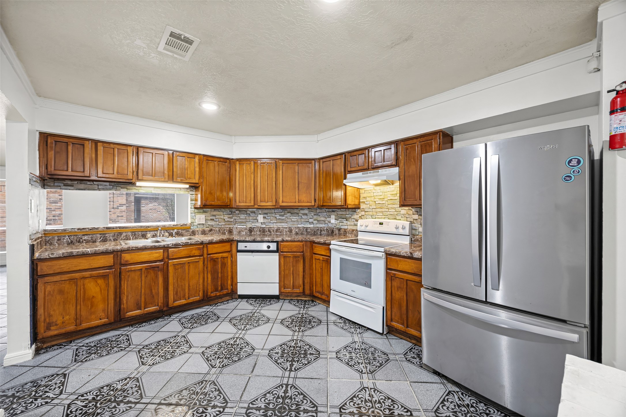 7226 Ridgeberry Drive Houston, TX 77095 - Photo 9 of 31 a kitchen with stainless steel appliances granite countertop a refrigerator and stove