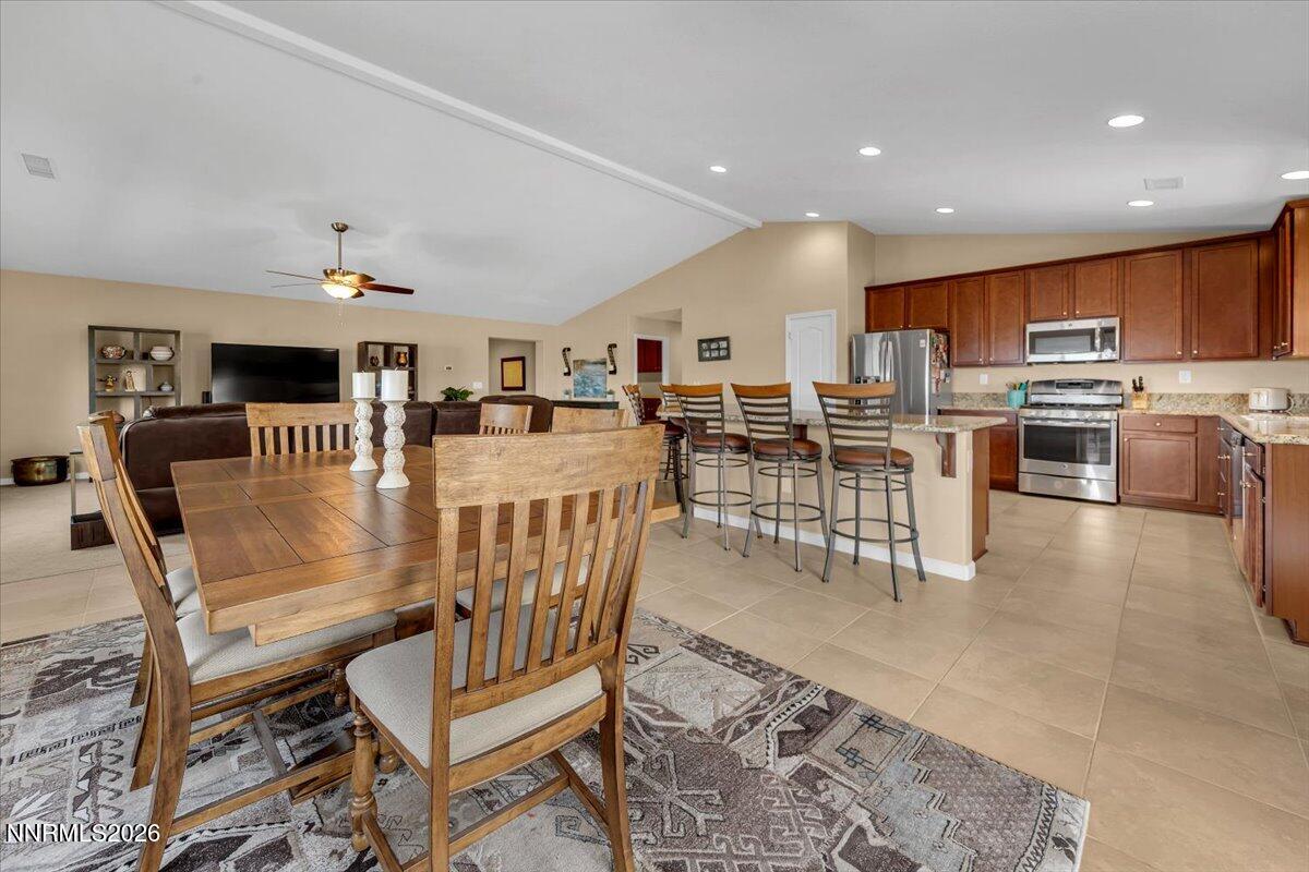 104 Bethpage Road Dayton, NV 89403 - Photo 10 of 65 a living room with stainless steel appliances furniture a rug and a kitchen view