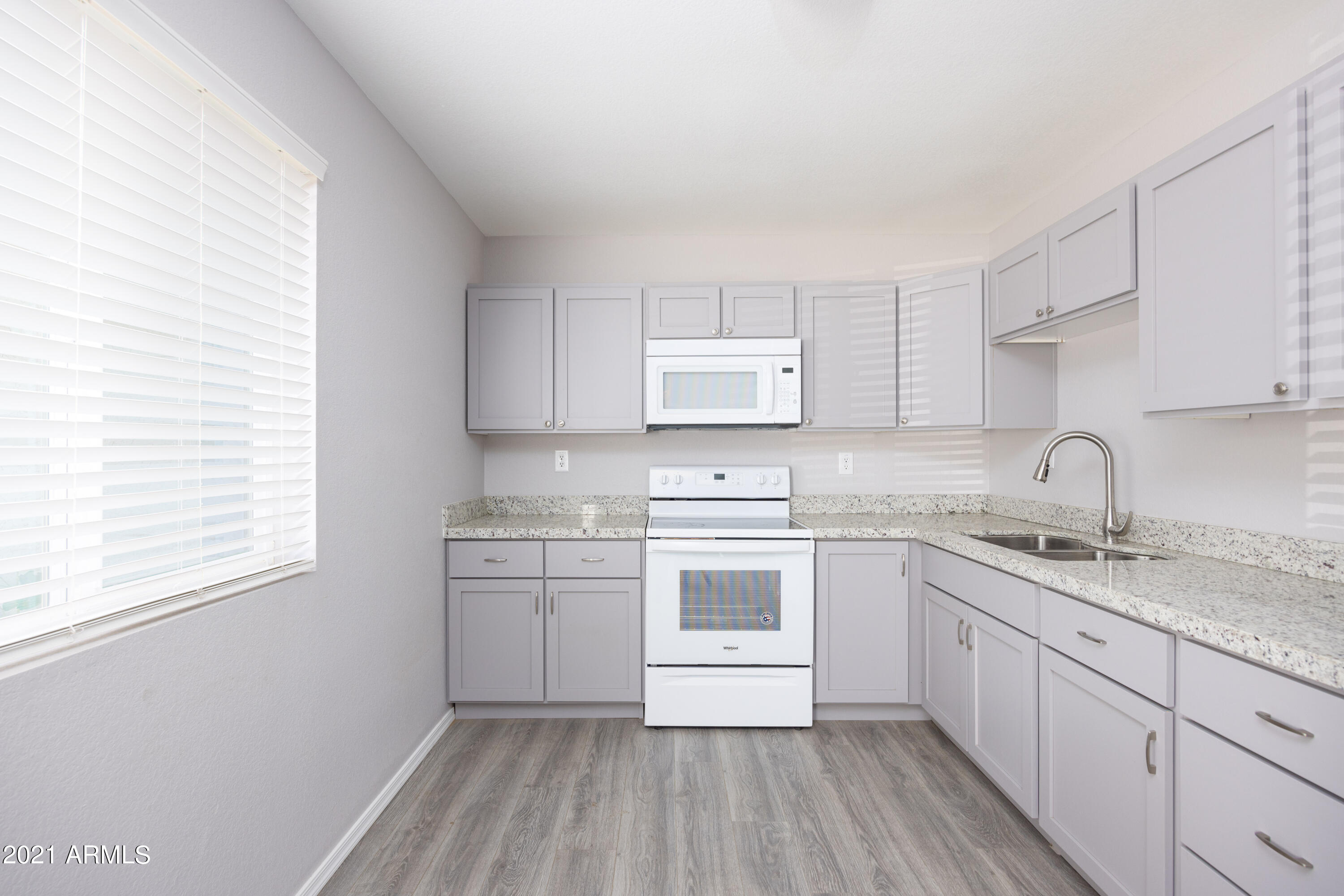 a kitchen with stainless steel appliances granite countertop white cabinets stove a sink and dishwasher