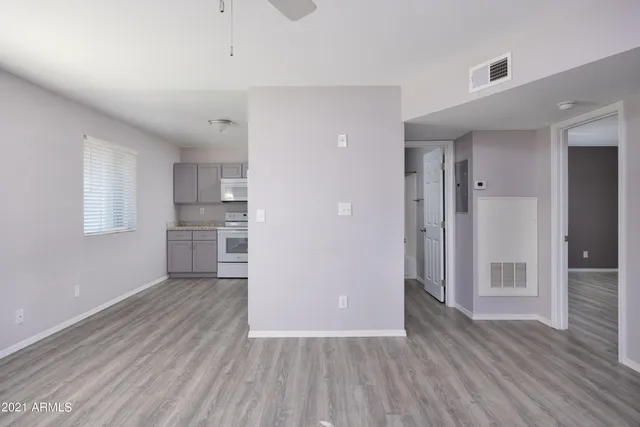 a view of a kitchen with wooden floor and a kitchen