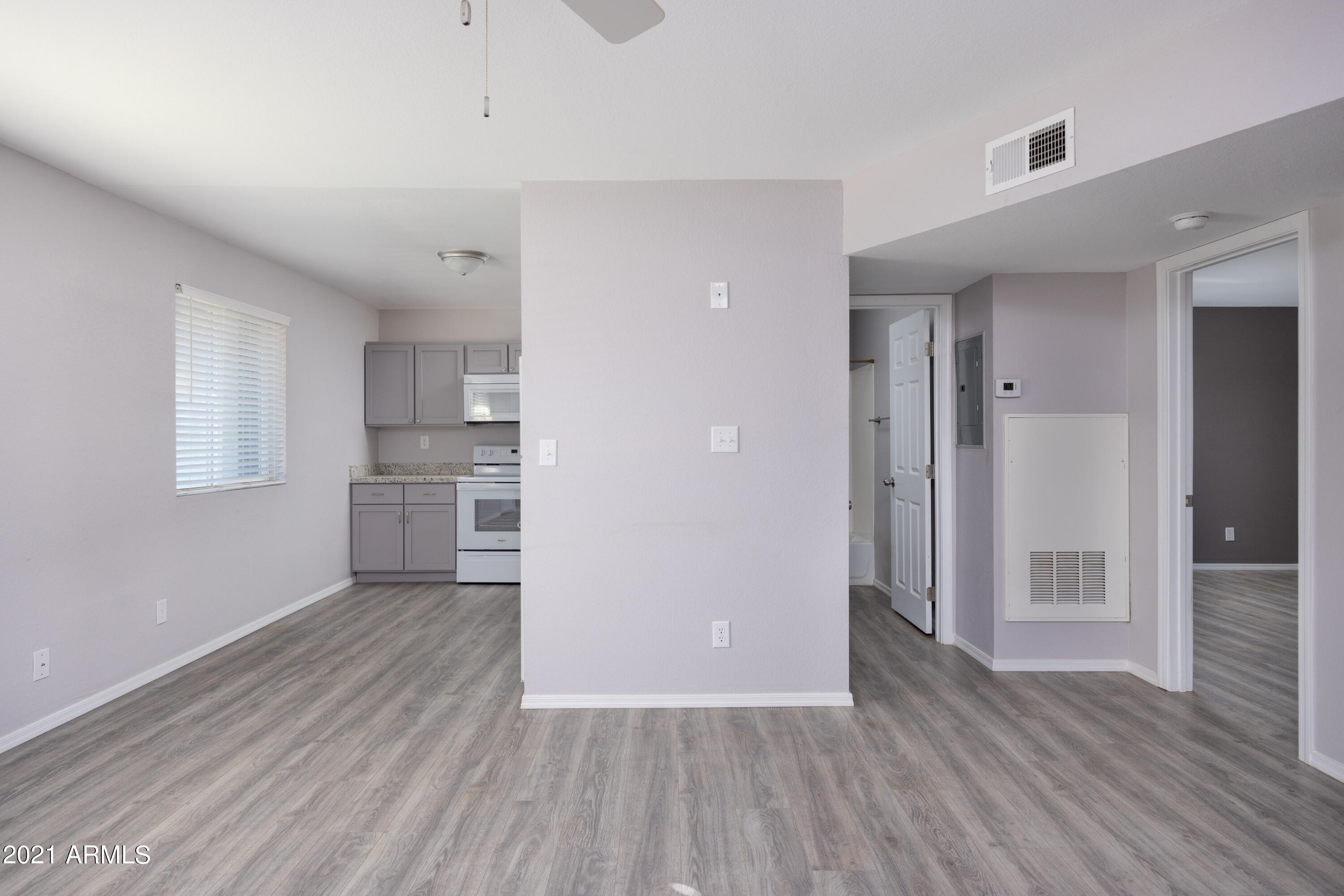15605 North 29th Street, Unit 12 Phoenix, AZ 85032 - Photo 13 of 25 a view of a kitchen with wooden floor and a kitchen