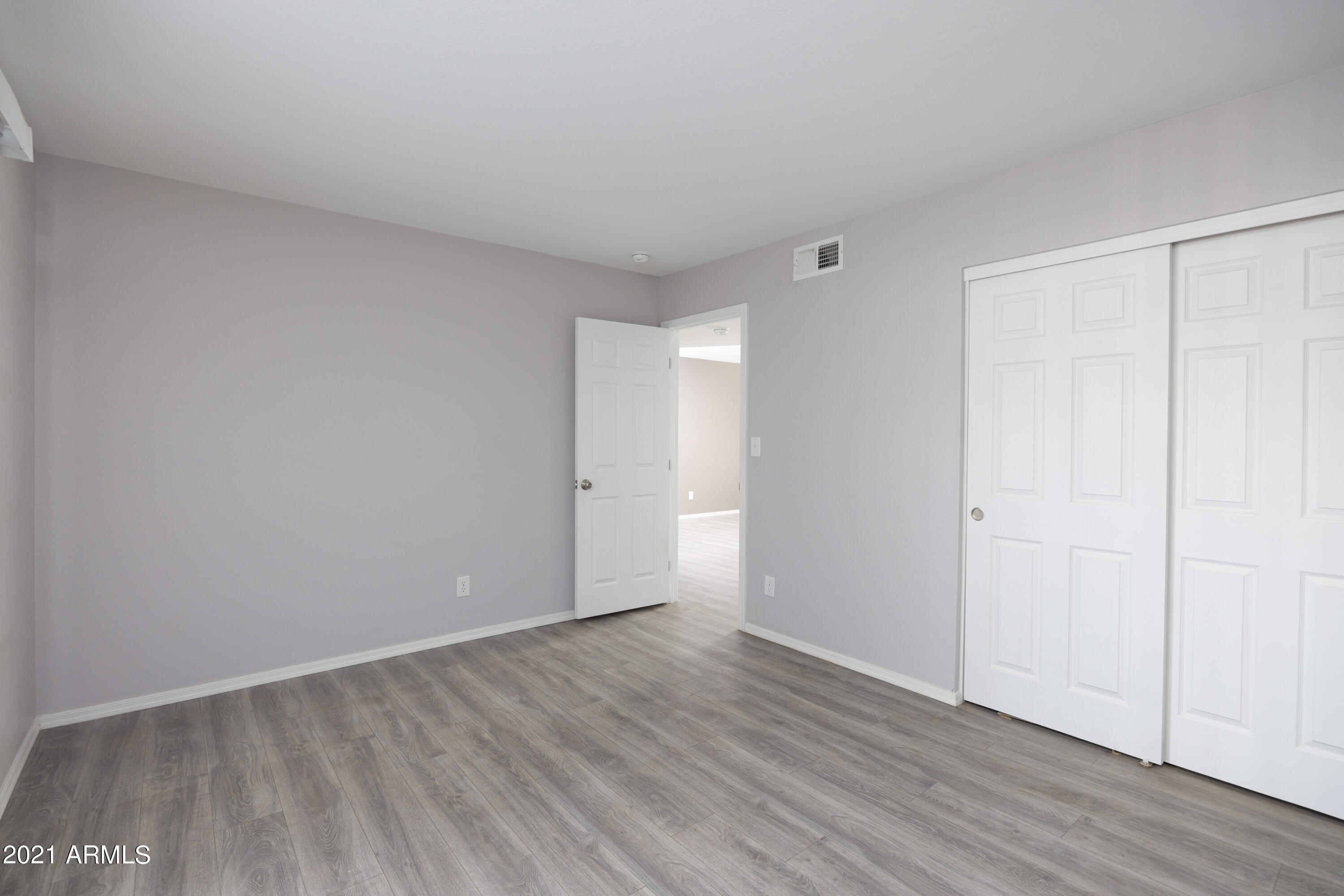 15605 North 29th Street, Unit 12 Phoenix, AZ 85032 - Photo 17 of 25 a view of an empty room with wooden floor