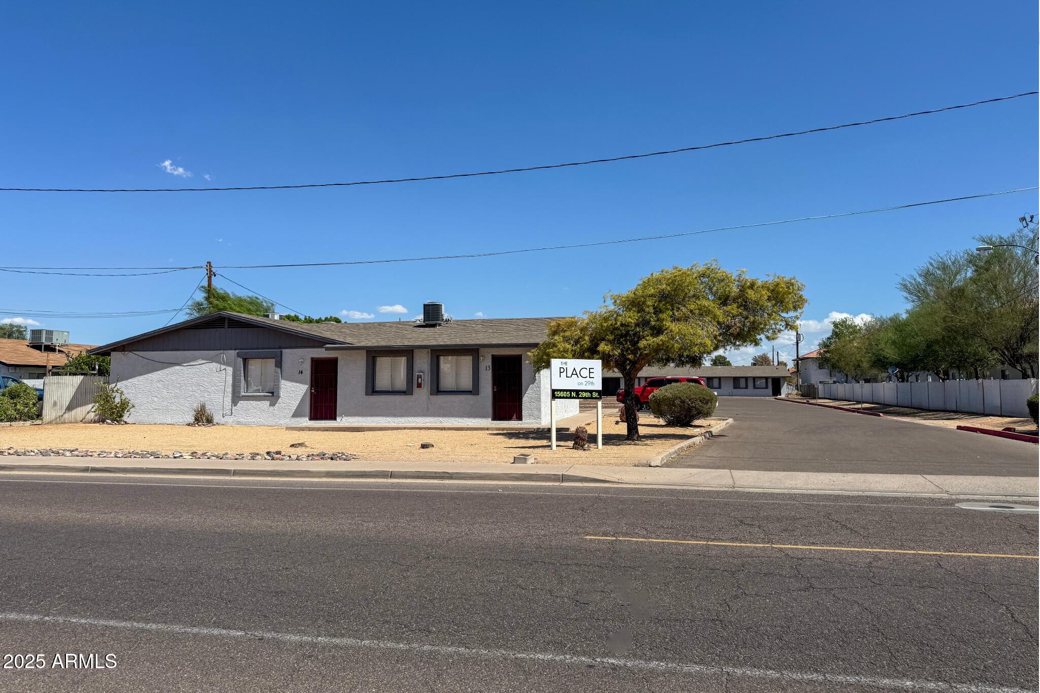 15605 North 29th Street, Unit 12 Phoenix, AZ 85032 - Photo 2 of 25 a view of a car parked in front of a building