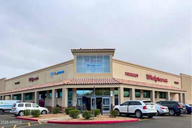 a front view of multi story building with retail shop and retail shops