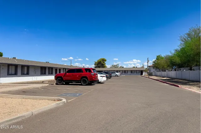 a view of a cars park in front of a building