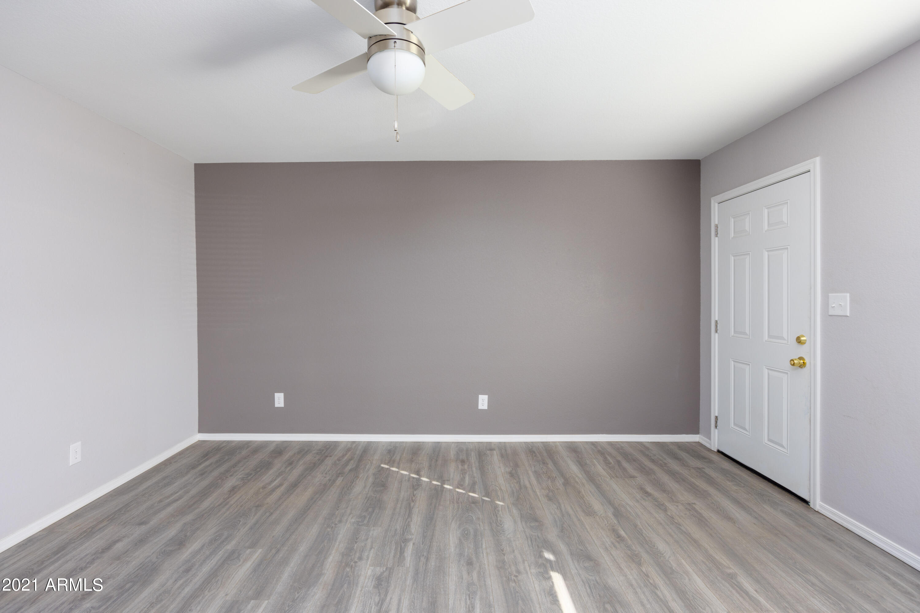 15605 North 29th Street, Unit 12 Phoenix, AZ 85032 - Photo 8 of 25 a view of an empty room with wooden floor and a window