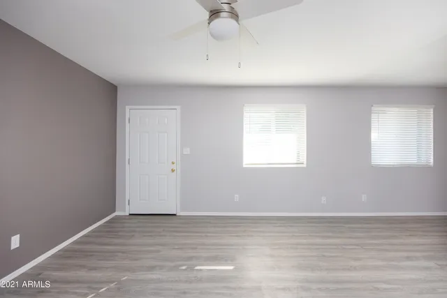 a view of a livingroom with wooden floor and a window