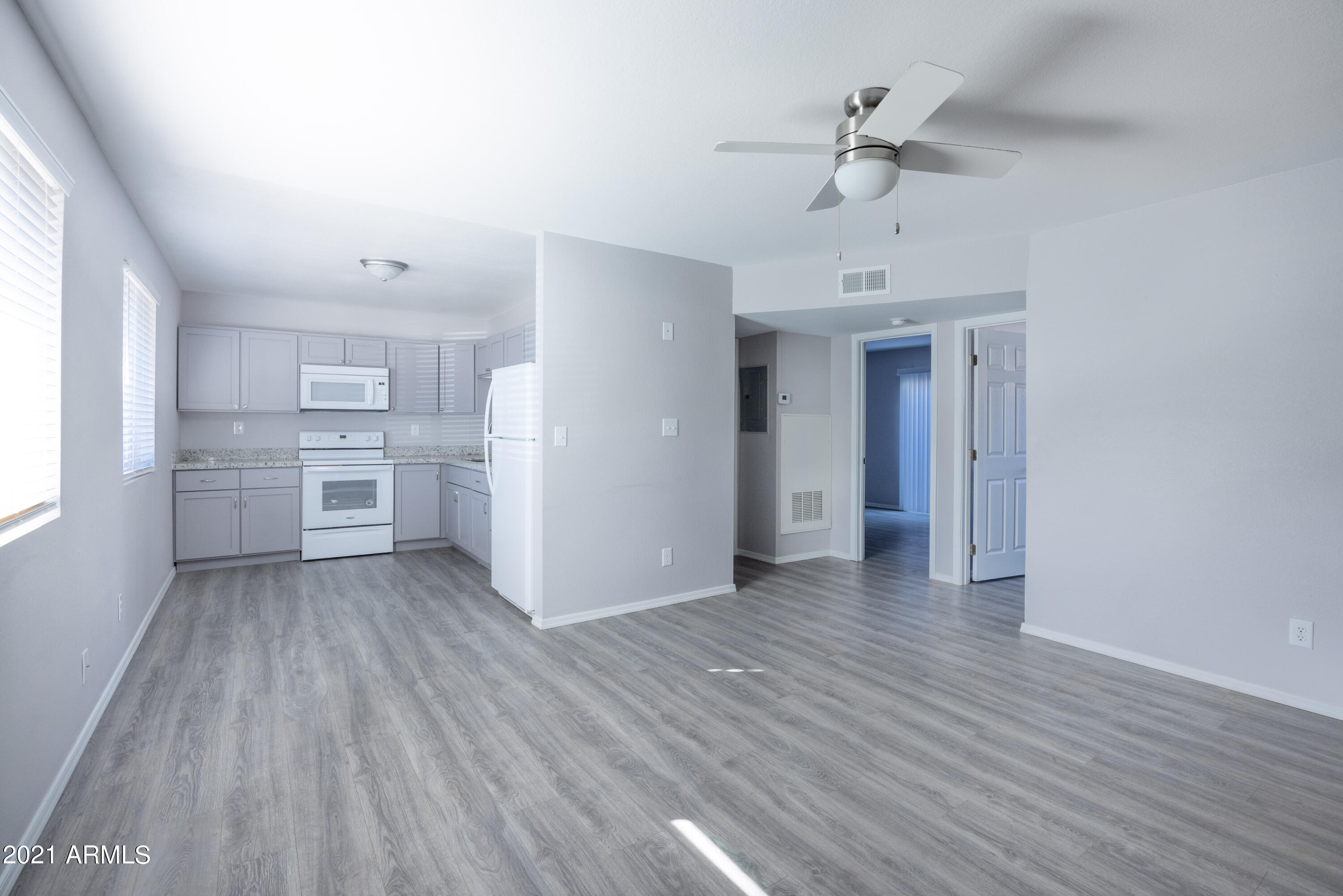 15605 North 29th Street, Unit 12 Phoenix, AZ 85032 - Photo 10 of 25 a view of a kitchen with a white cabinet and a stove top oven