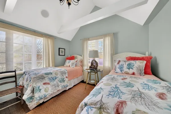 a bedroom with two beds and a window