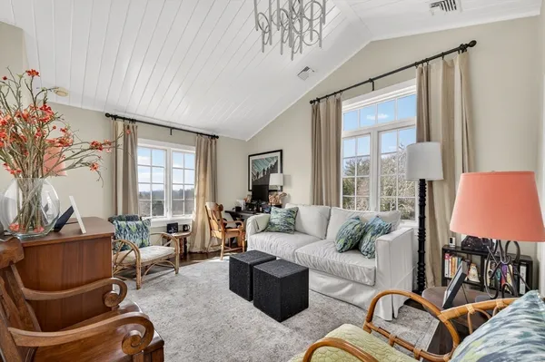 a living room with furniture and a floor to ceiling window