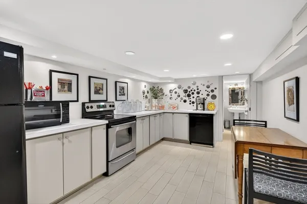 a large kitchen with stainless steel appliances a large counter top and a stove