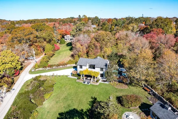 an aerial view of a house with a yard