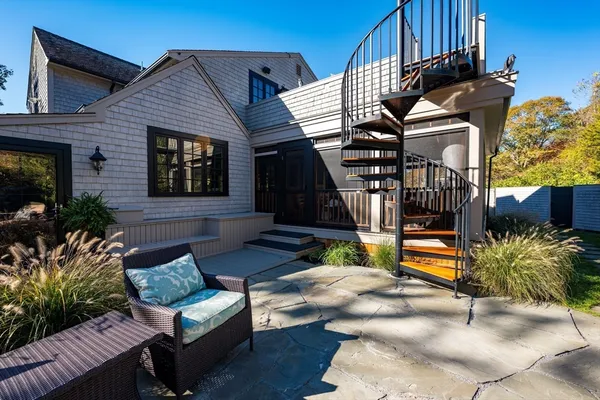 a view of a house with backyard and sitting area