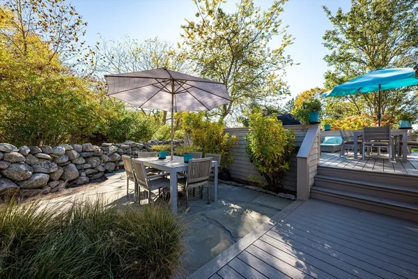 a view of a patio with table and chairs potted plants with wooden floor