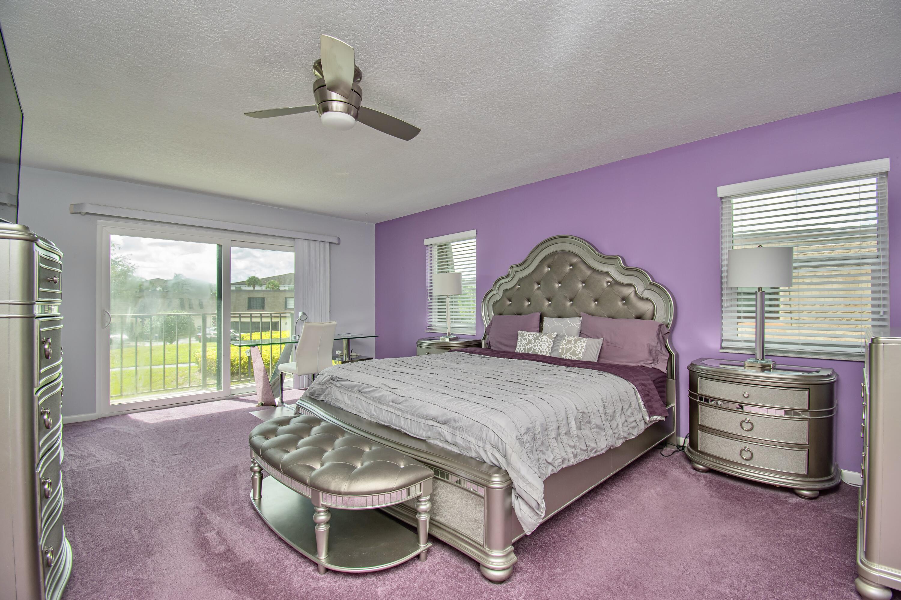 9460 Southwest 61st Way, Unit B Boca Raton, FL 33428 - Photo 16 of 31 a bedroom with a bed and a large window