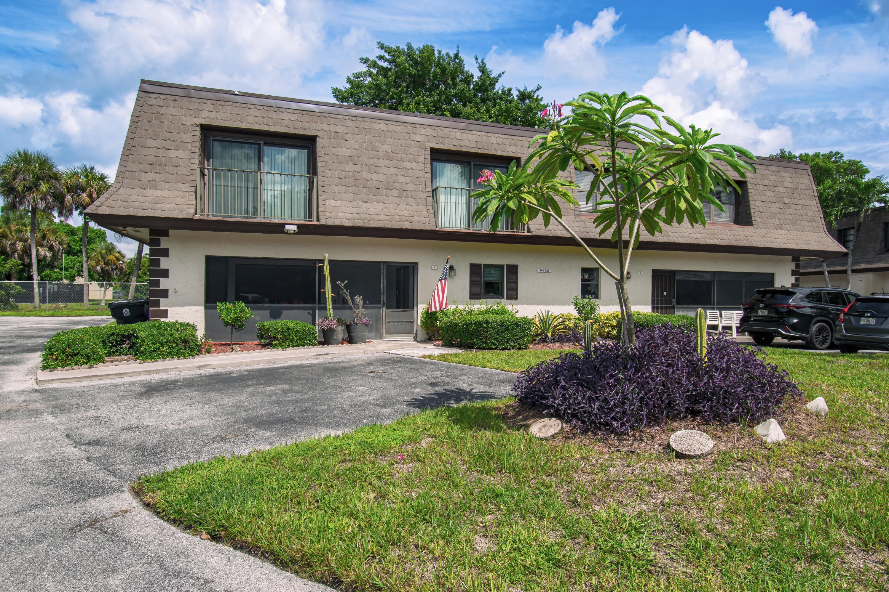 9460 Southwest 61st Way, Unit B Boca Raton, FL 33428 - Photo 2 of 31 a front view of a house with garden