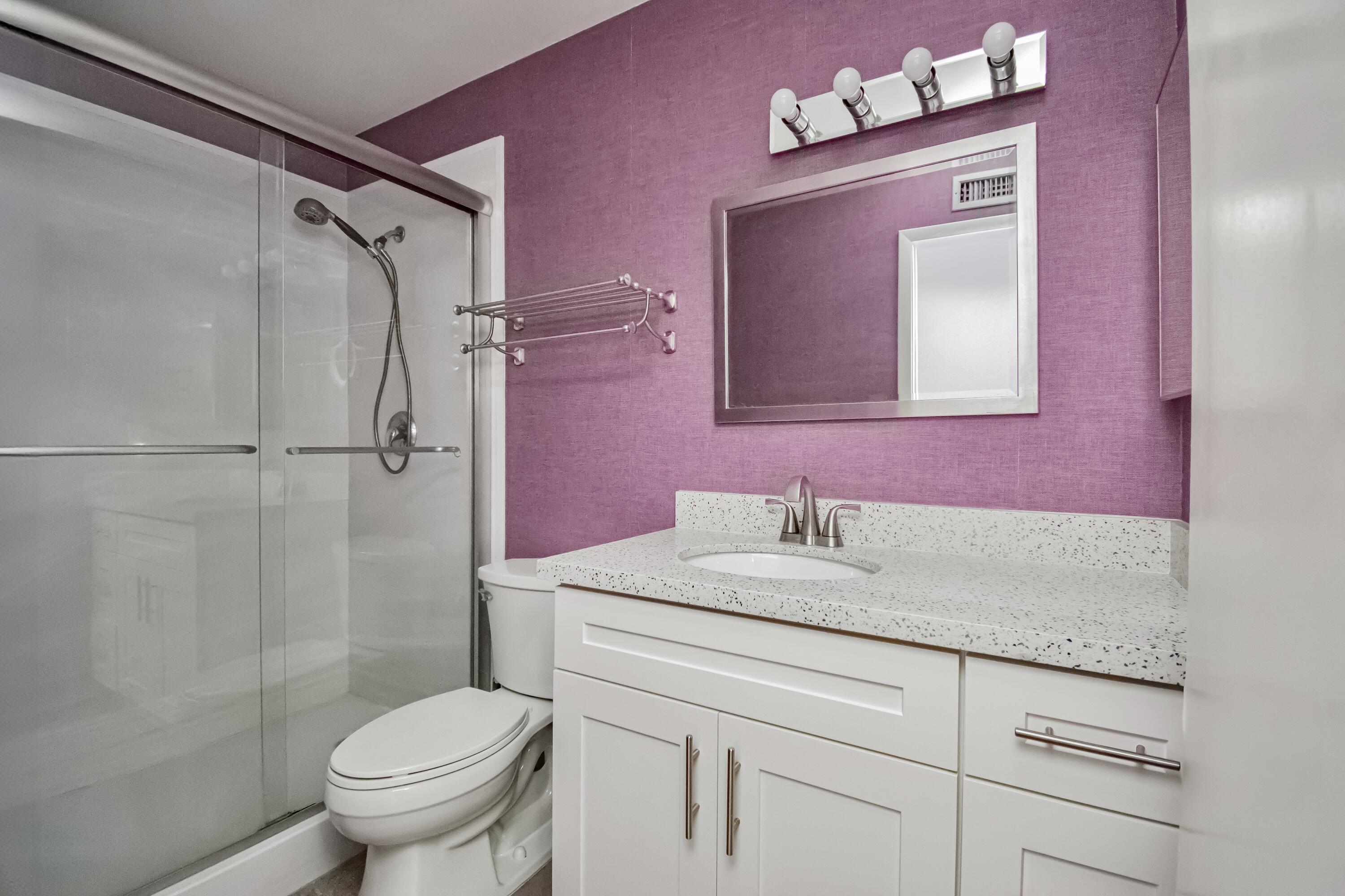 9460 Southwest 61st Way, Unit B Boca Raton, FL 33428 - Photo 24 of 31 a bathroom with a sink vanity mirror and toilet