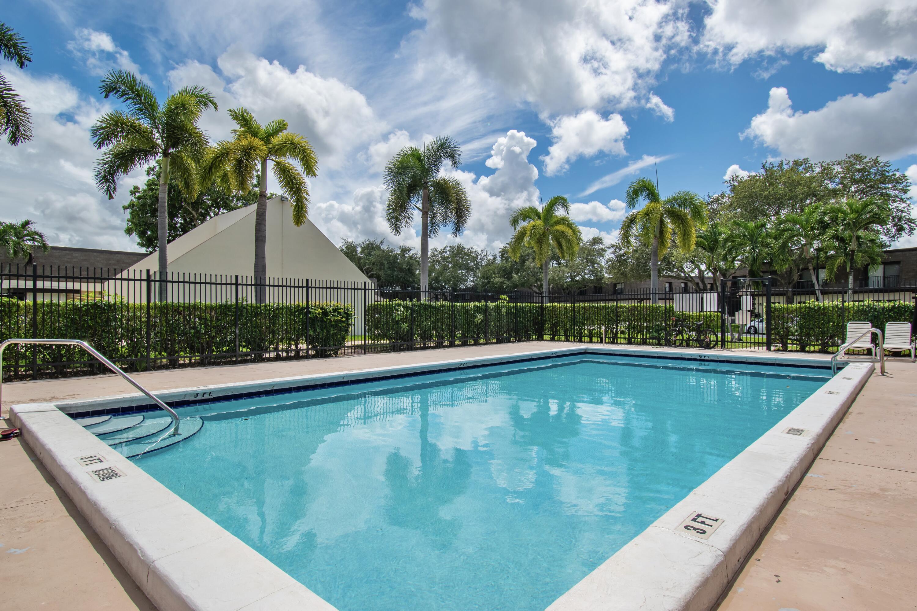 9460 Southwest 61st Way, Unit B Boca Raton, FL 33428 - Photo 30 of 31 a view of a swimming pool with a yard