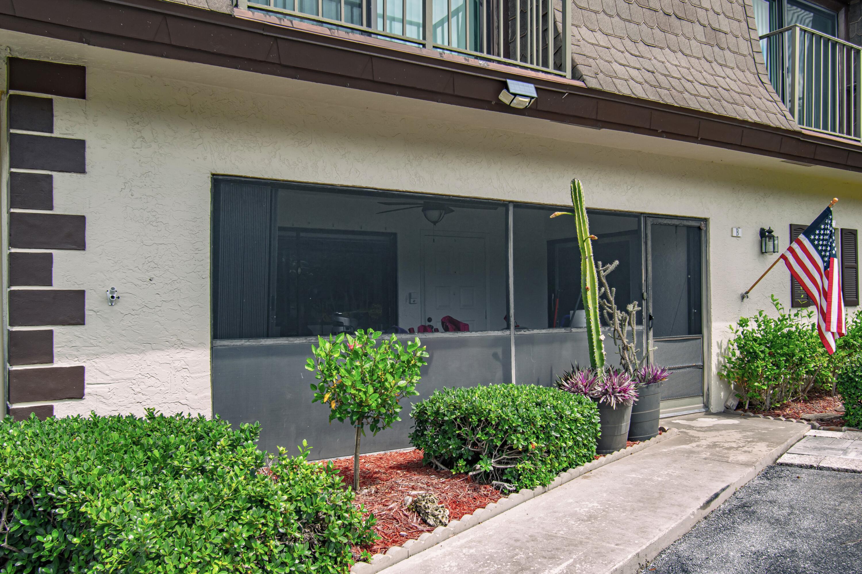 9460 Southwest 61st Way, Unit B Boca Raton, FL 33428 - Photo 4 of 31 a front view of a house with garden
