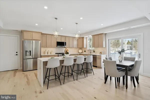 a view of kitchen with cabinets table and chairs