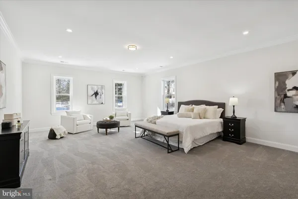 a spacious bedroom with a bed and a couch