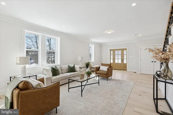 a living room with furniture and floor to ceiling windows