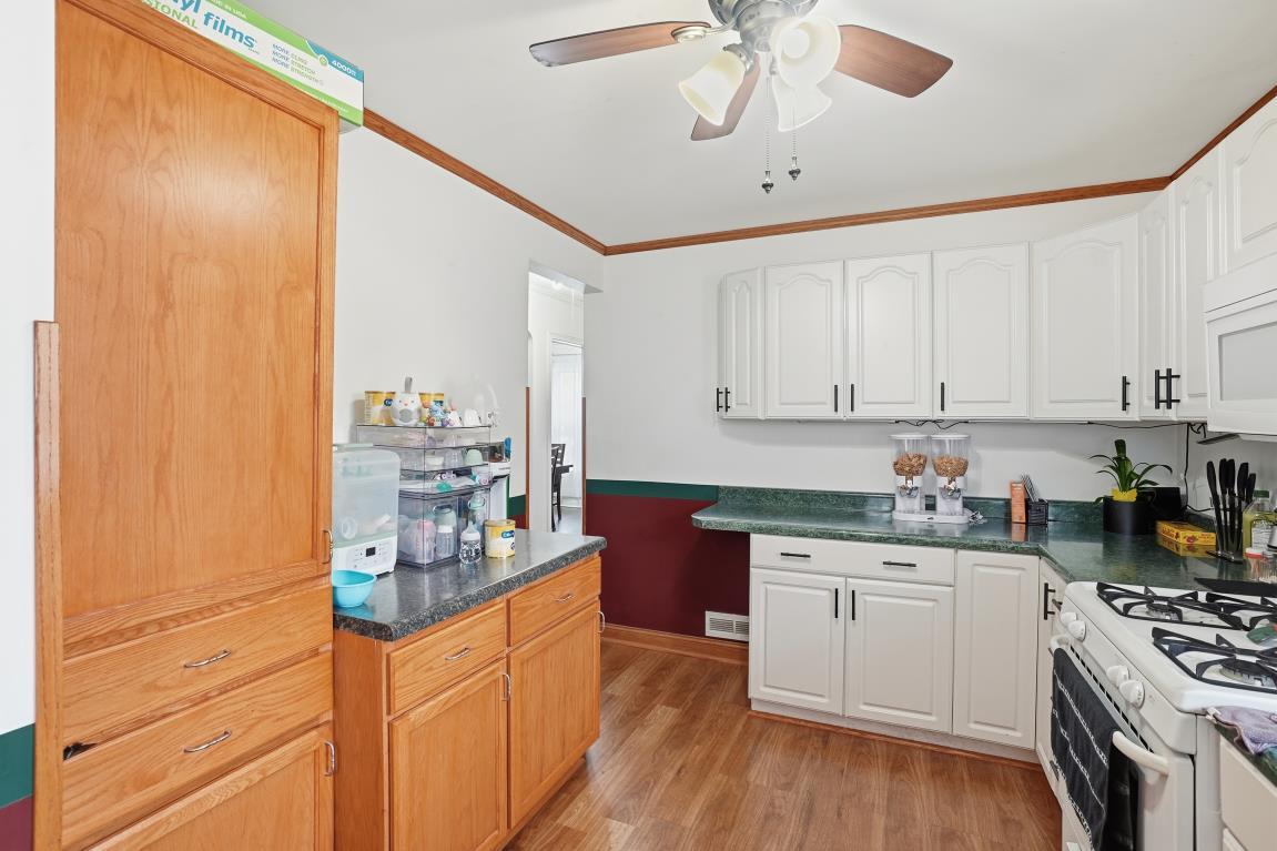4240 Custer Avenue Brookfield, IL 60513 - Photo 17 of 28 a kitchen with stainless steel appliances a sink stove and cabinets