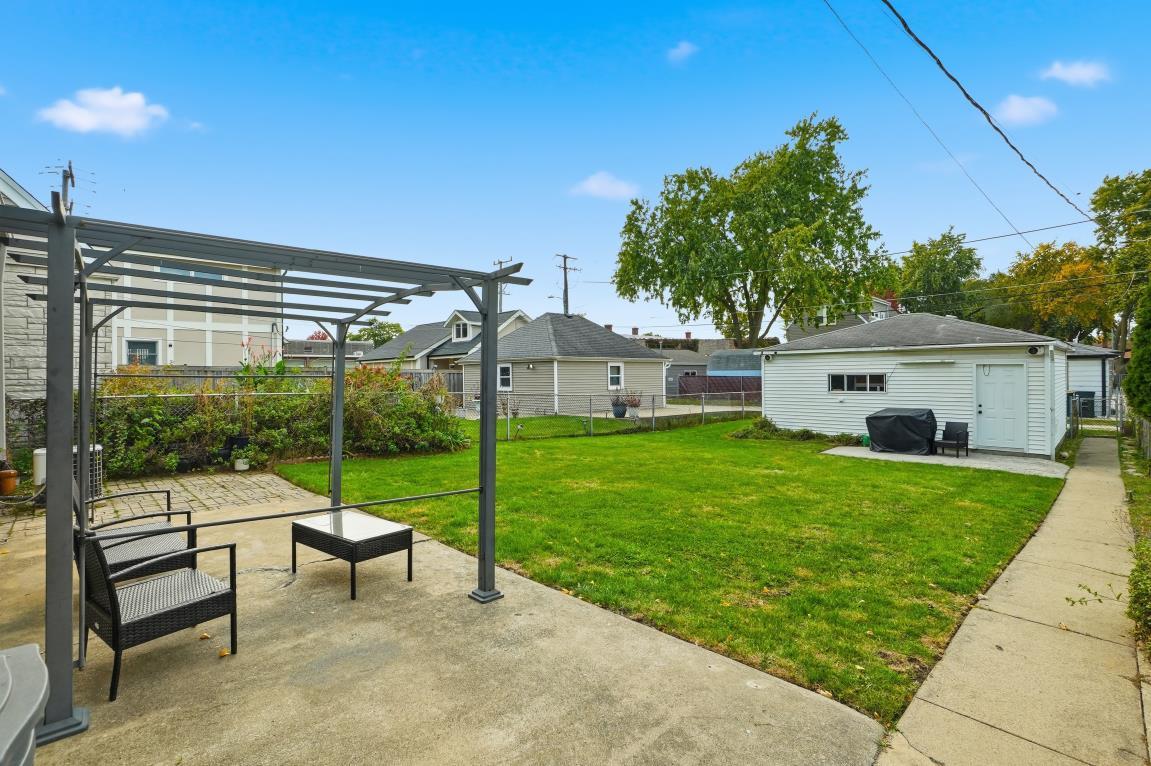 4240 Custer Avenue Brookfield, IL 60513 - Photo 22 of 28 a view of a house with backyard sitting area and garden