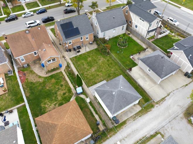 4240 Custer Avenue Brookfield, IL 60513 - Photo 27 of 28 an aerial view of a house with a garden and trees