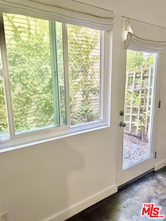 511 Rialto Avenue, Unit 1 Venice, CA 90291 - Photo 7 of 17 a view of an empty room with wooden floor and a window