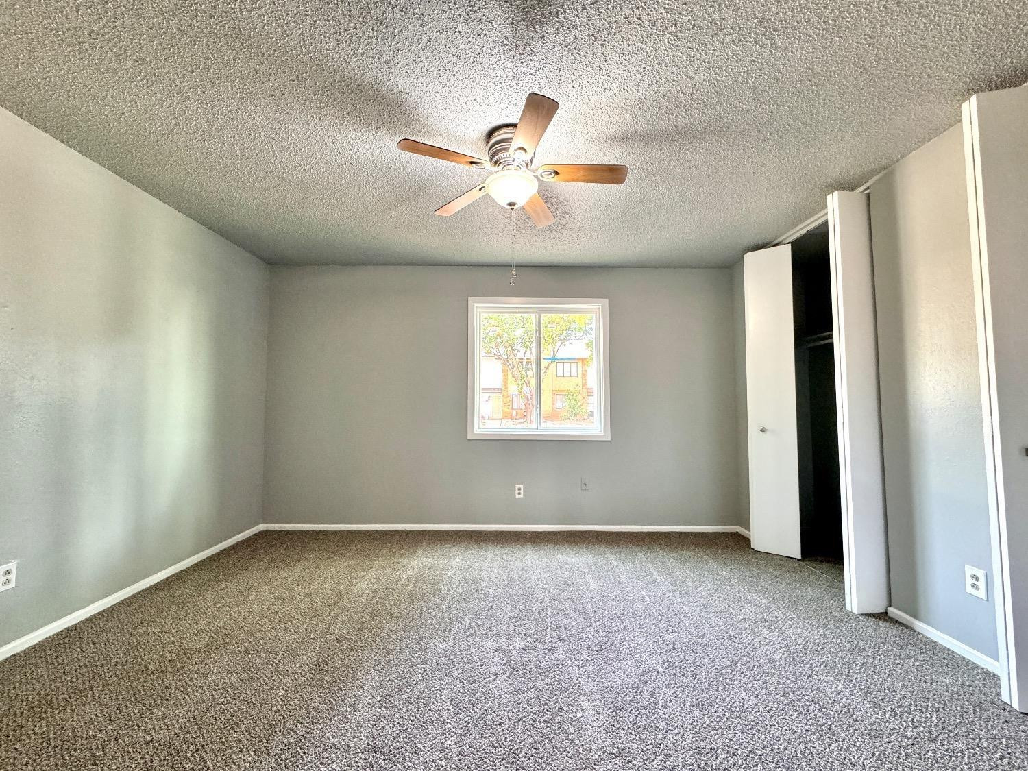 5763 38th Street Lubbock, TX 79407 - Photo 8 of 16 an empty room with windows and fan