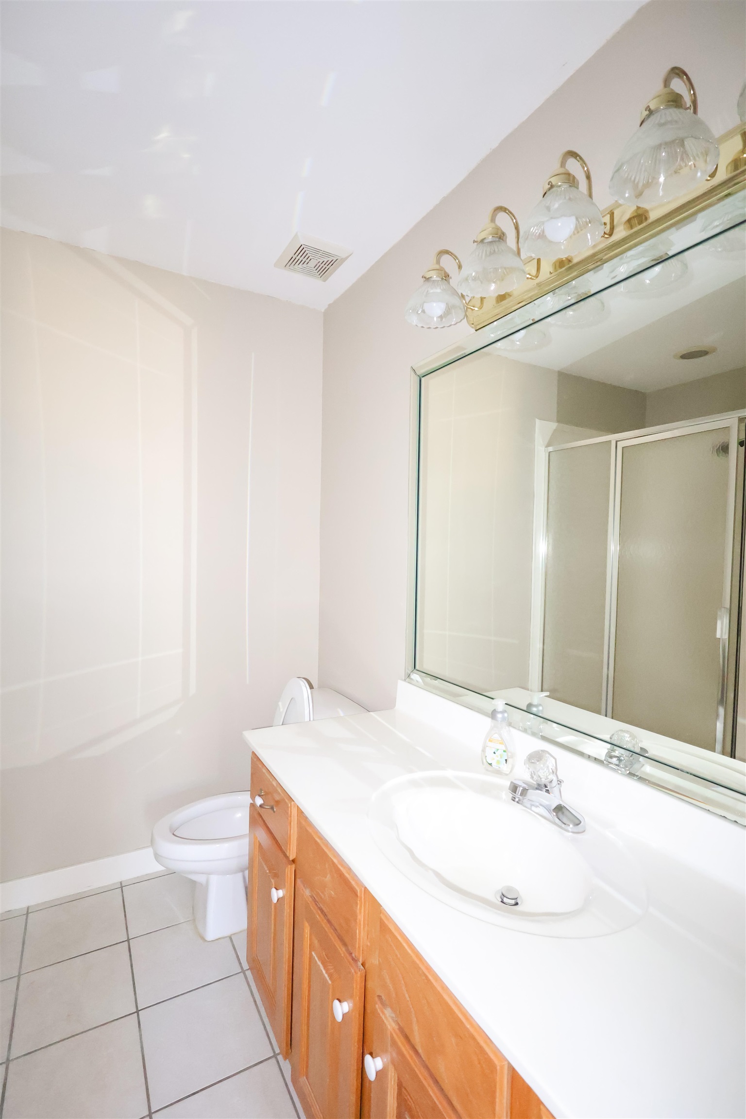 121 Reed Circle Drummonds, TN 38023 - Photo 27 of 38 Bathroom with tile patterned floors, toilet, a shower with door, and vanity