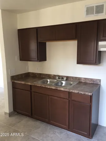 a kitchen with granite countertop stainless steel appliances a sink and a microwave