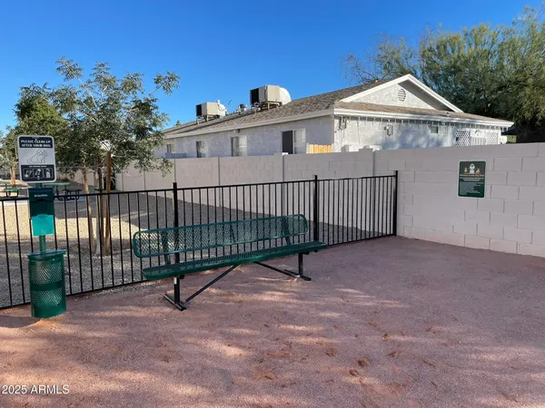 a view of a white house with a small yard and plants