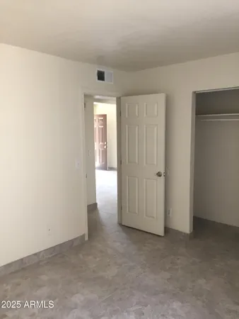 an empty room with closet area