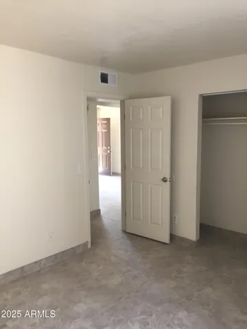 an empty room with closet area