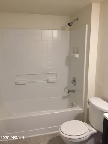 a bathroom with a toilet and a bath tub