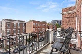 321 Summit Avenue, Unit 301 Boston, MA 02135 - Photo 6 of 6 a view of a balcony with two chairs and wooden fence