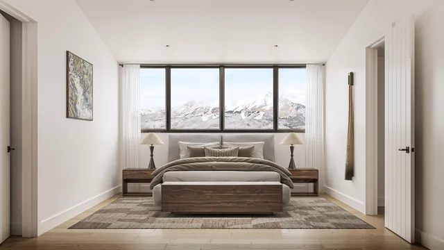 a bedroom with a bed and a large window