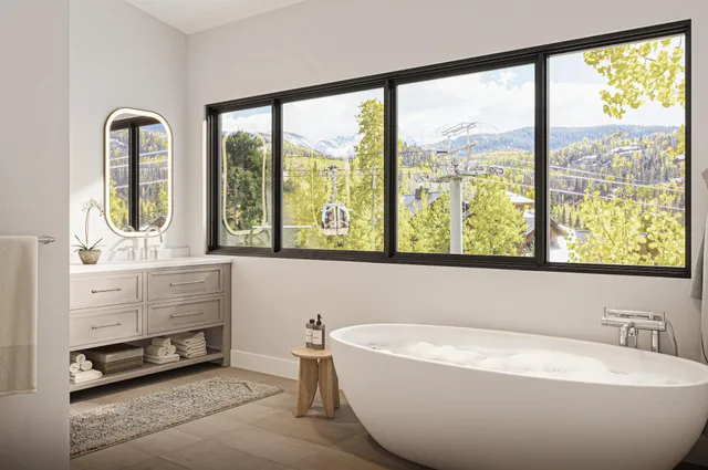 a bathroom with a bathtub and windows